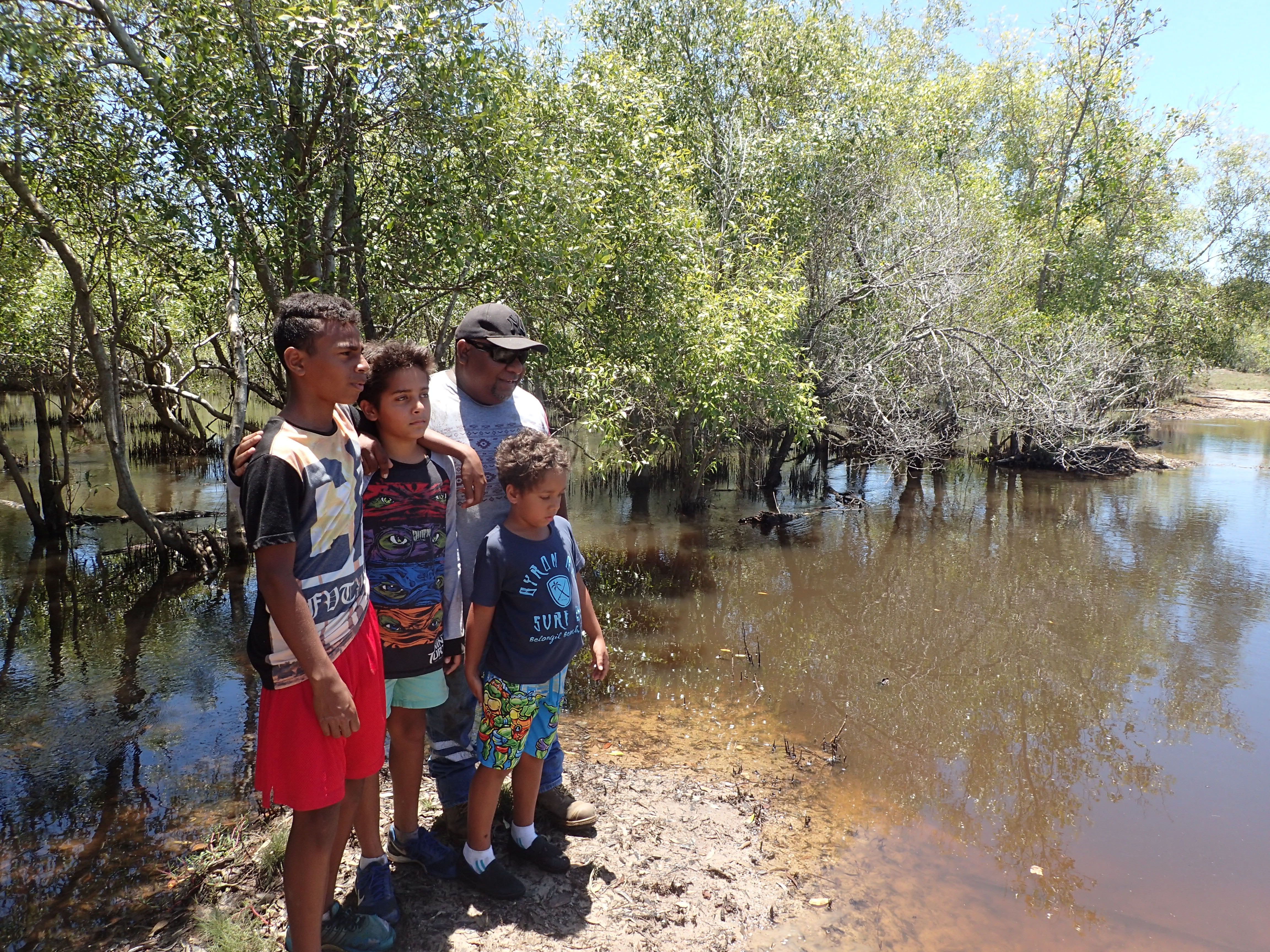 Photo of indigenous ranger and family at bund wall, Mungalla station