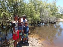 Photo of indigenous ranger and family at bund wall, Mungalla station