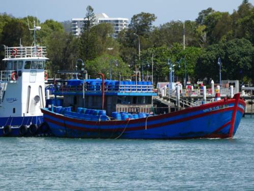 Foreign fishing vessel with sea cucumber cargo and tug