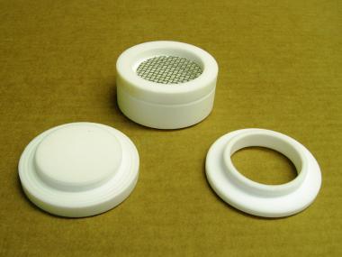 An Empore Disk casing that has been disassembled. The Empore Disk is a small flat disk that goes in this casing